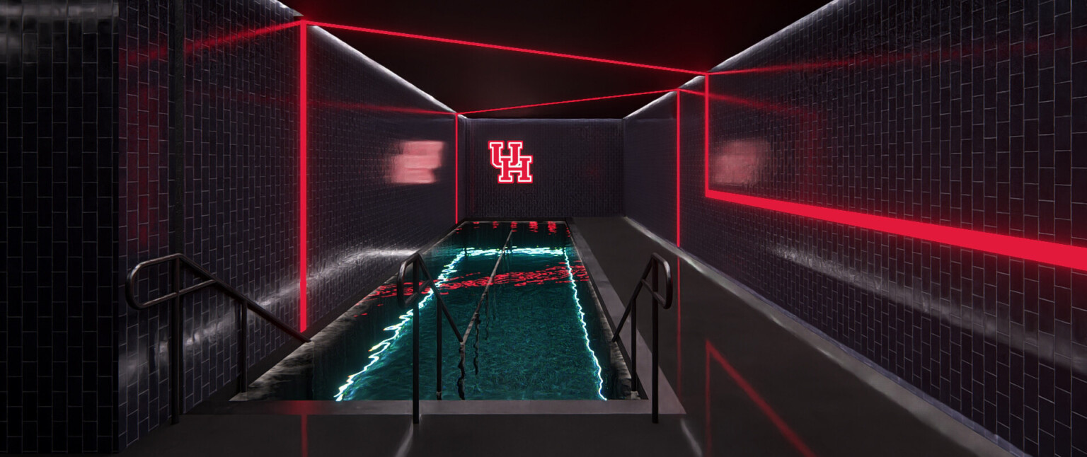 Indoor pool with black walls, red light accents, and a red logo on the back