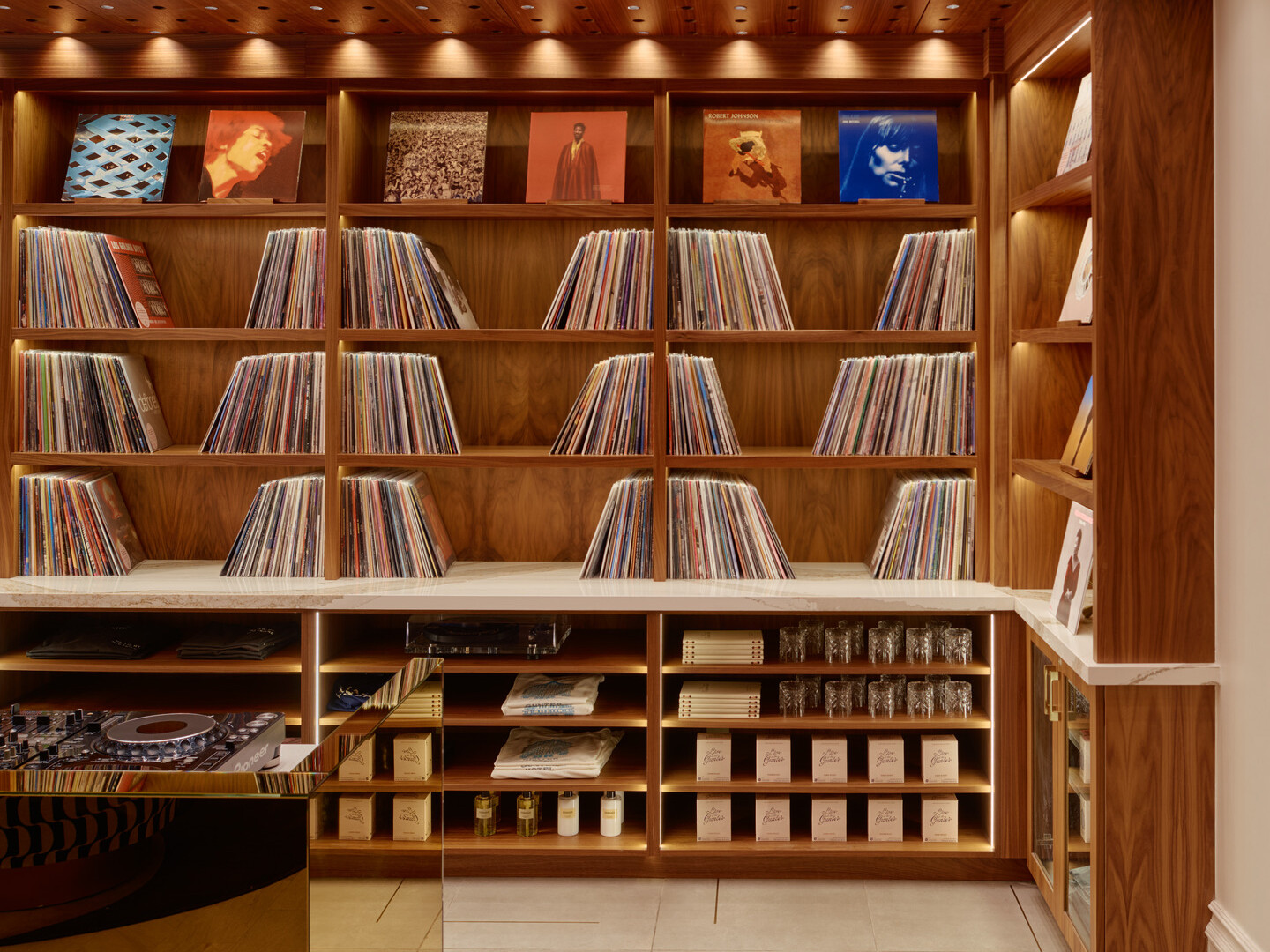 record library and lobby market at the Gunter Hotel, with a glimpse of the gold DJ booth and turntable.