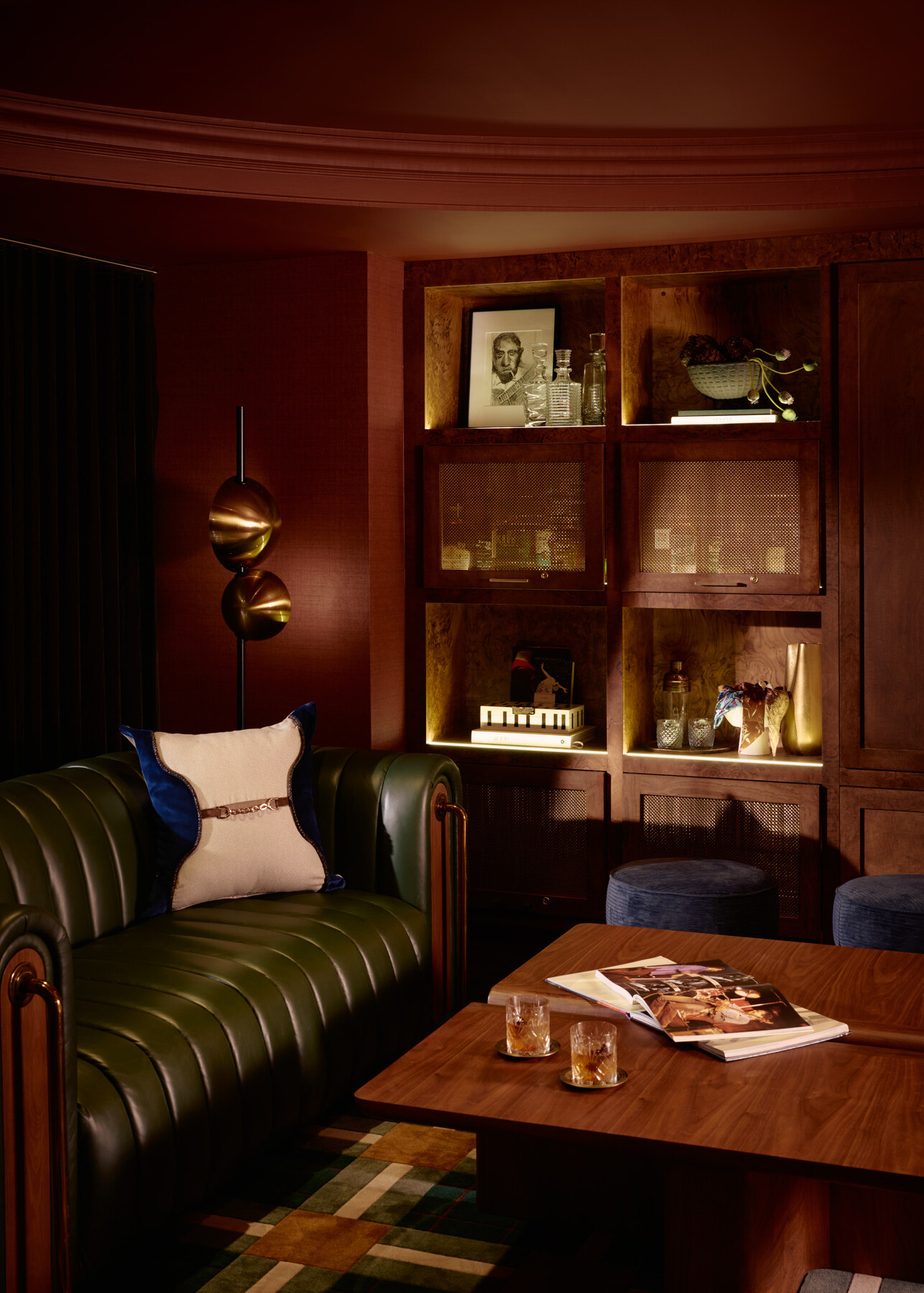seating group in the Studio lounge at the Gunter Hotel sits before shelves that double as liquor lockers, displaying a charcoal drawing of Robert Johnson.