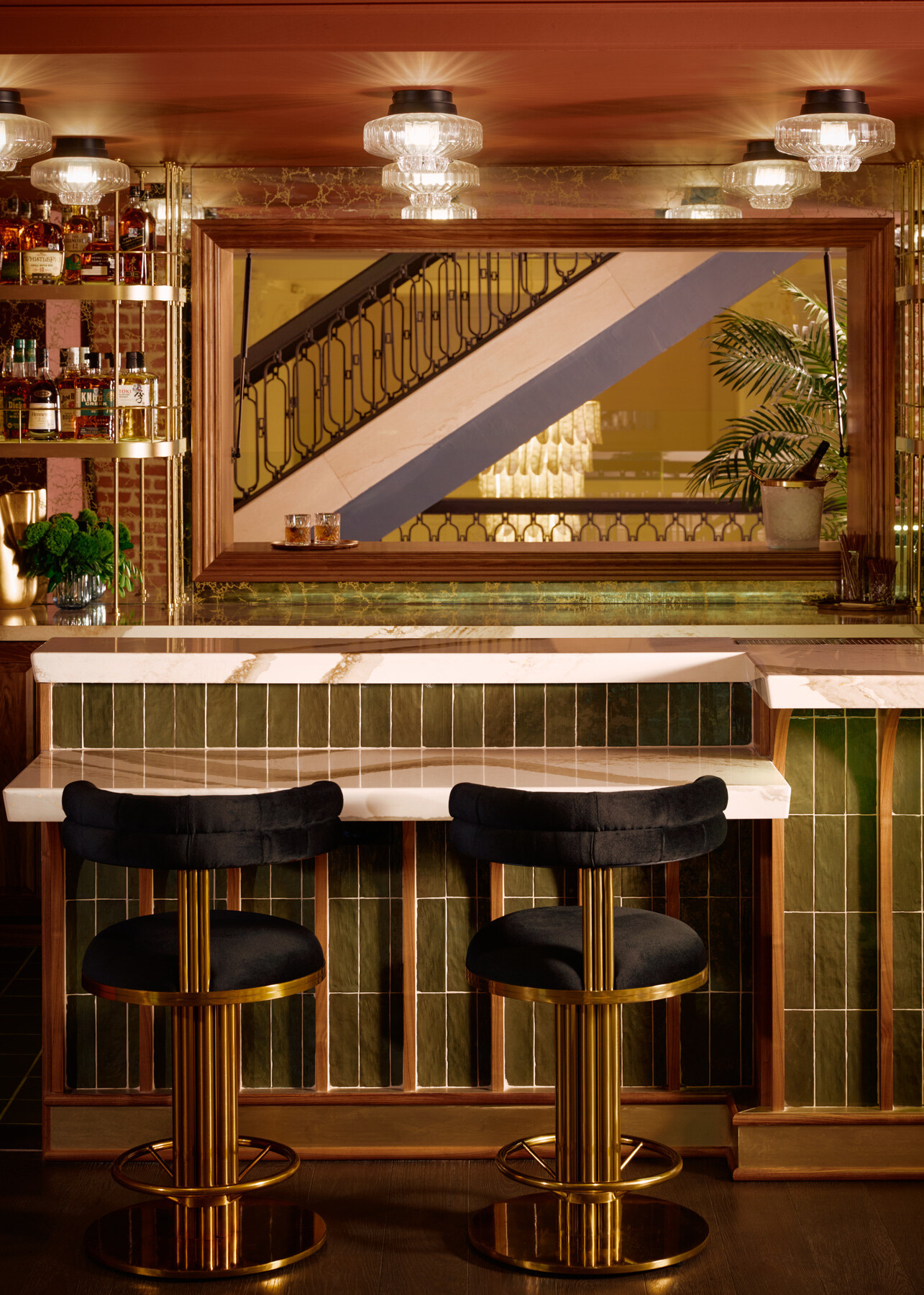 The Studio lounge bar at the Gunter Hotel, its hidden antique mirror swung open to the pre-function space, with a staircase rising to the third floor.