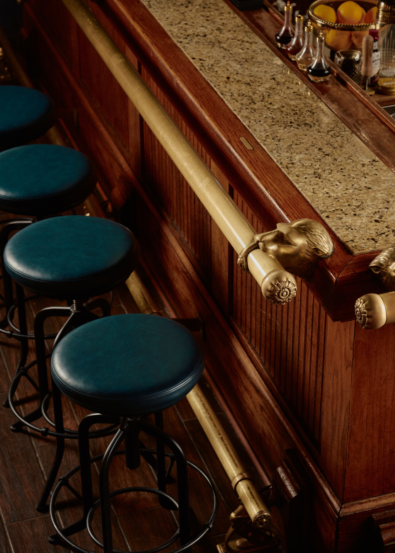 Corner of the bar in Bar 414 at the Gunter Hotel, with a bronze lion head and new barstools.