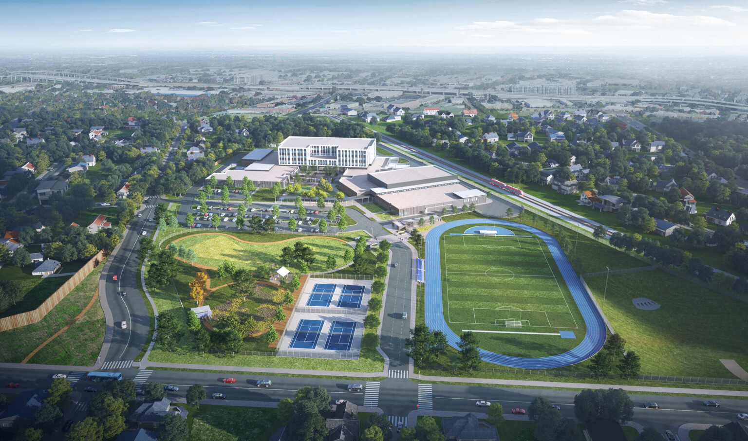 Burnet Middle School; aerial design rendering with a large football field with blue track surrounding and adjacent tennis courts; modern white building roof in the background
