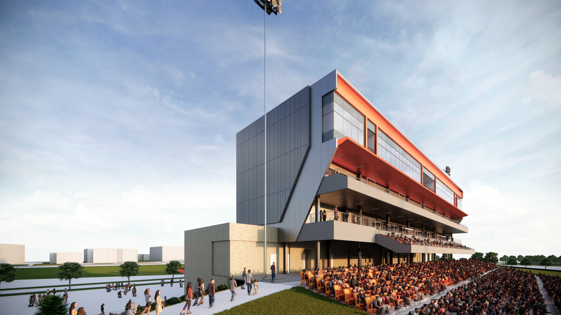 Modern sports stadium grandstand filled with spectators in orange seats below a large tower filled with windows and balconies
