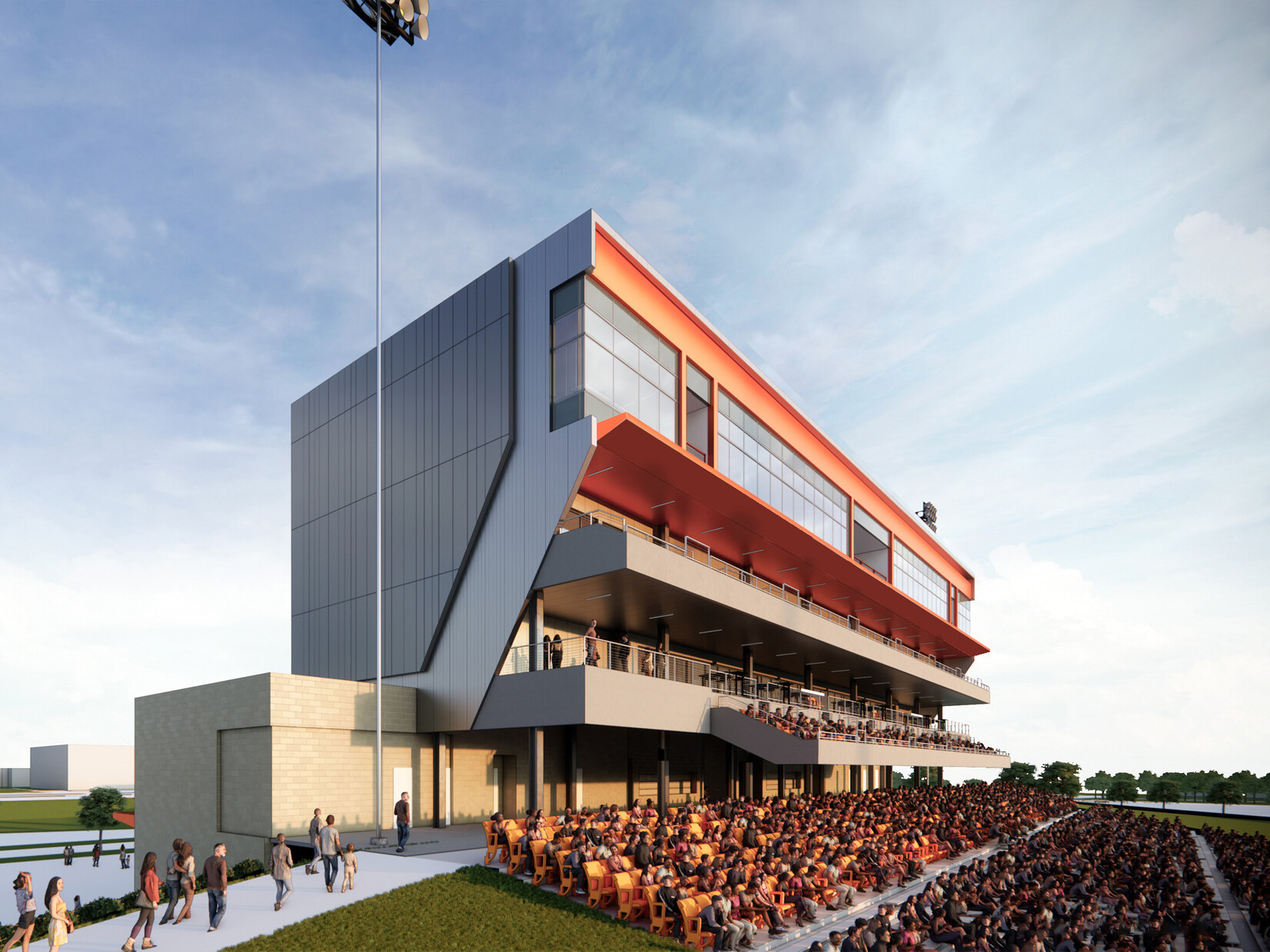 Modern sports stadium grandstand filled with spectators in orange seats below a large tower filled with windows and balconies