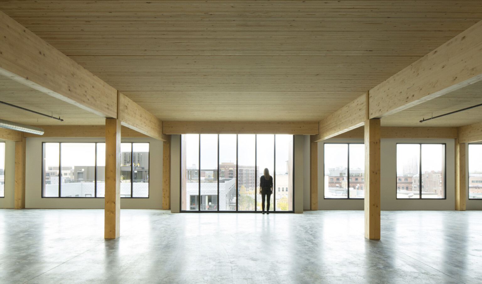 mass timber floor plate looking toward floor to ceiling windows mass timber floor plate looking toward floor to ceiling windows