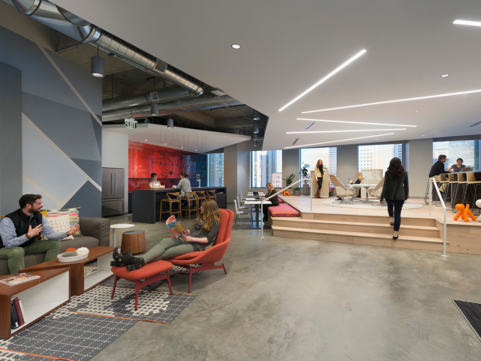 Communal modern office space with collaboration zones and communal kitchen in the background; DLR Group Denver office
