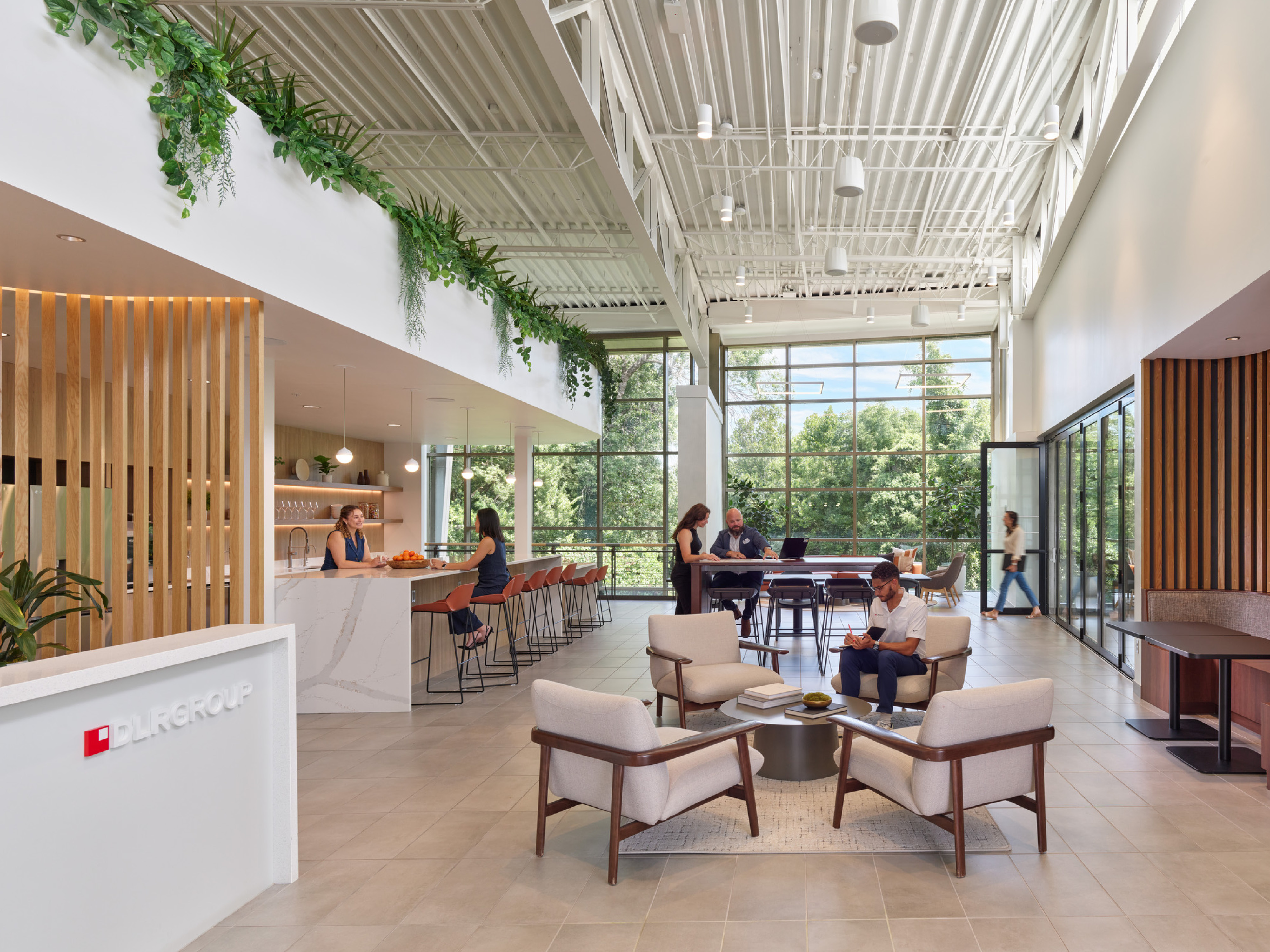 modern office communal kitchen area with bar seating and modular seating; DLR Group Kansas City office