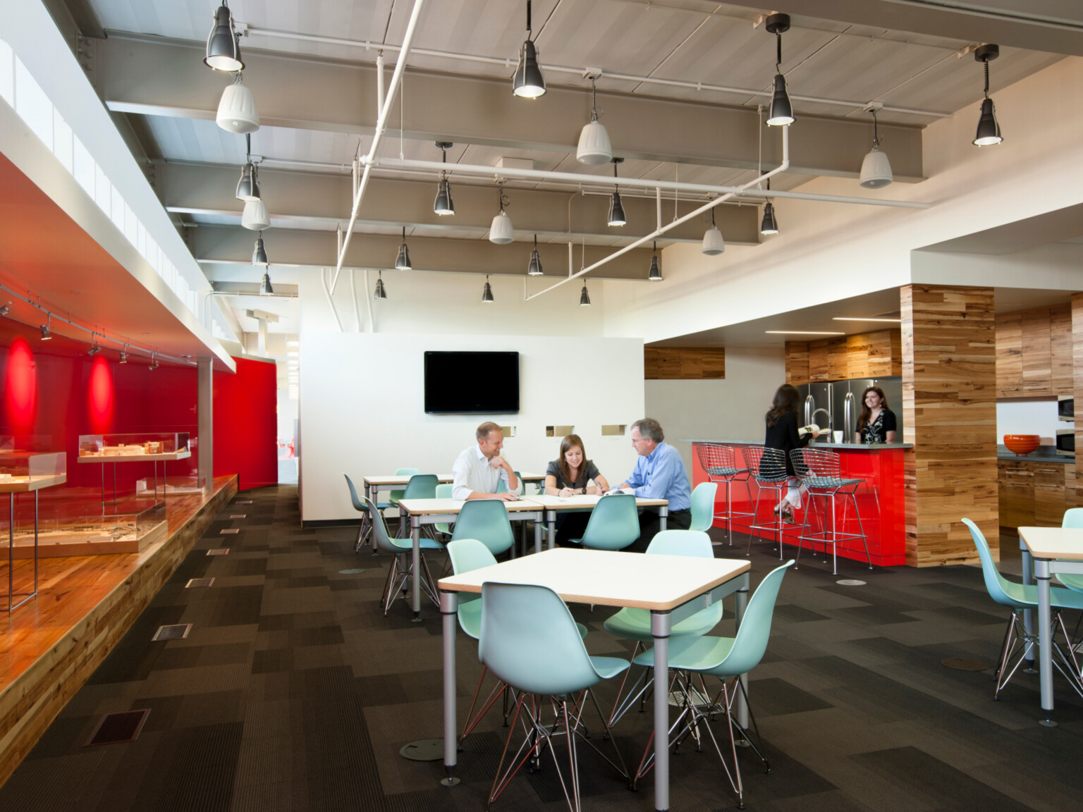 modern office collaboration zone with tables and high-top seating for eating and working; DLR Group Omaha office