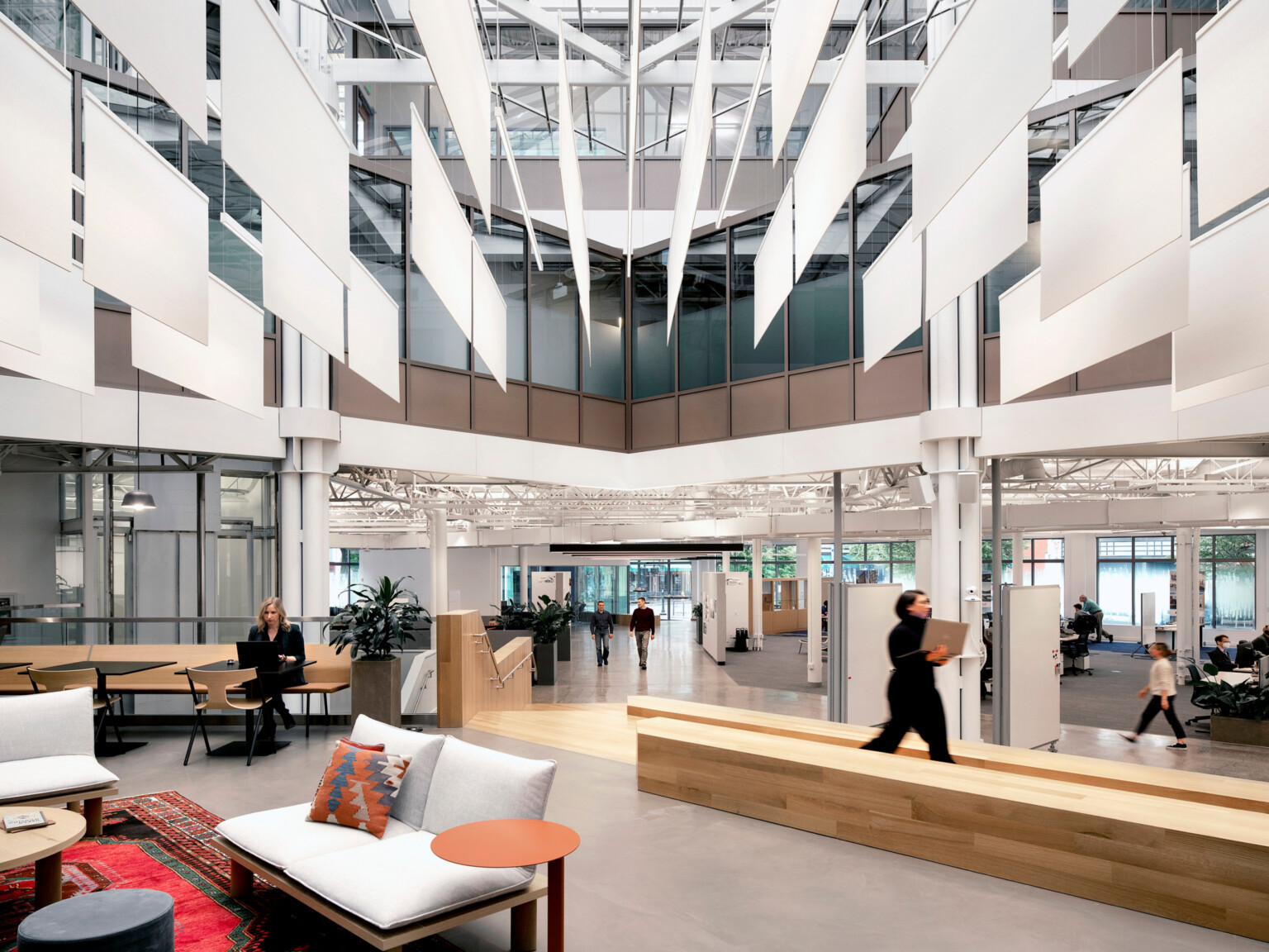 modern office walkway zone with seating and desking to the left and right of the major walkway; DLR Group Portland office