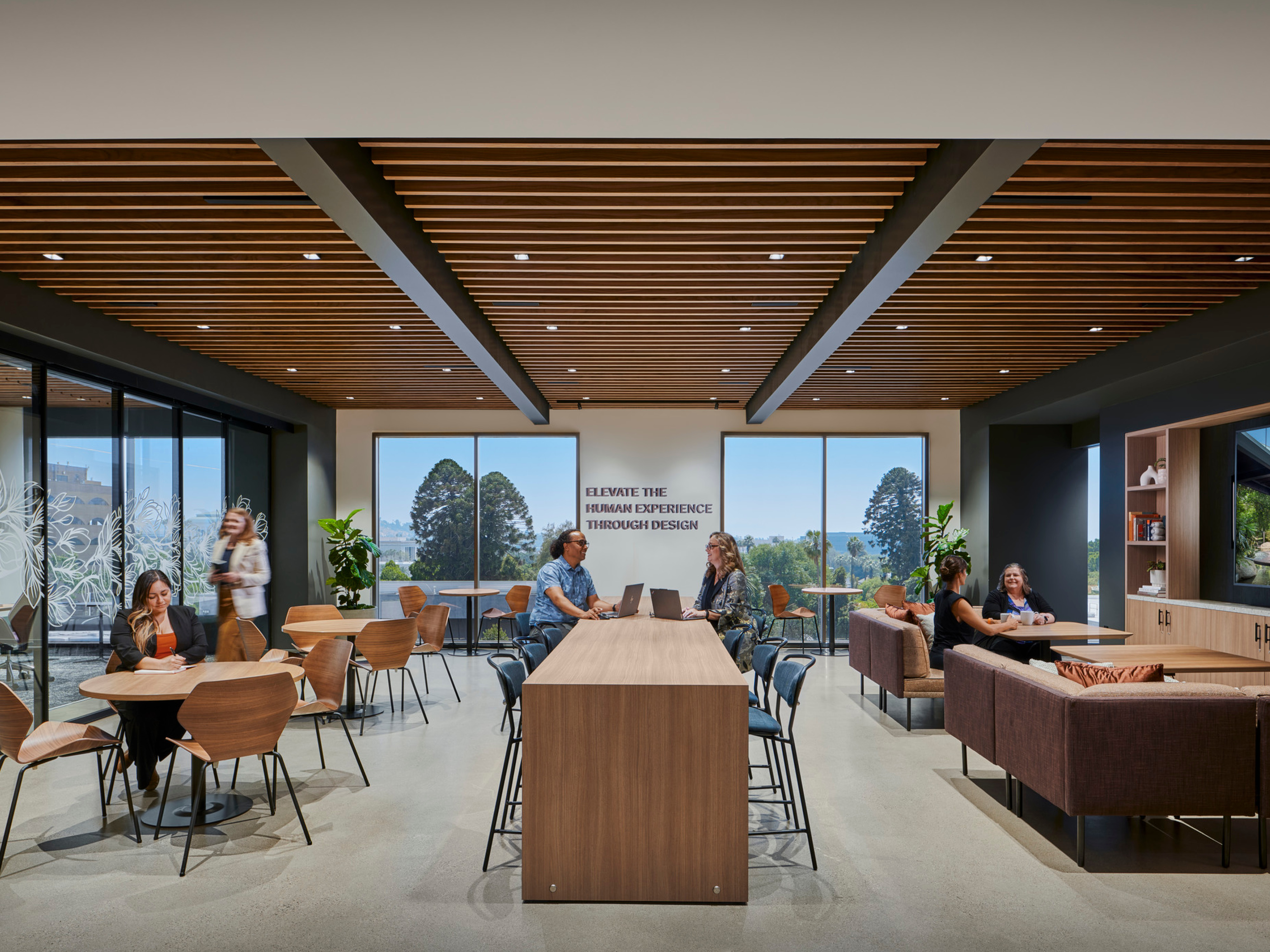 modern office collaboration space; booths, high-tops and tables throughout the space; DLR Group Riverside office