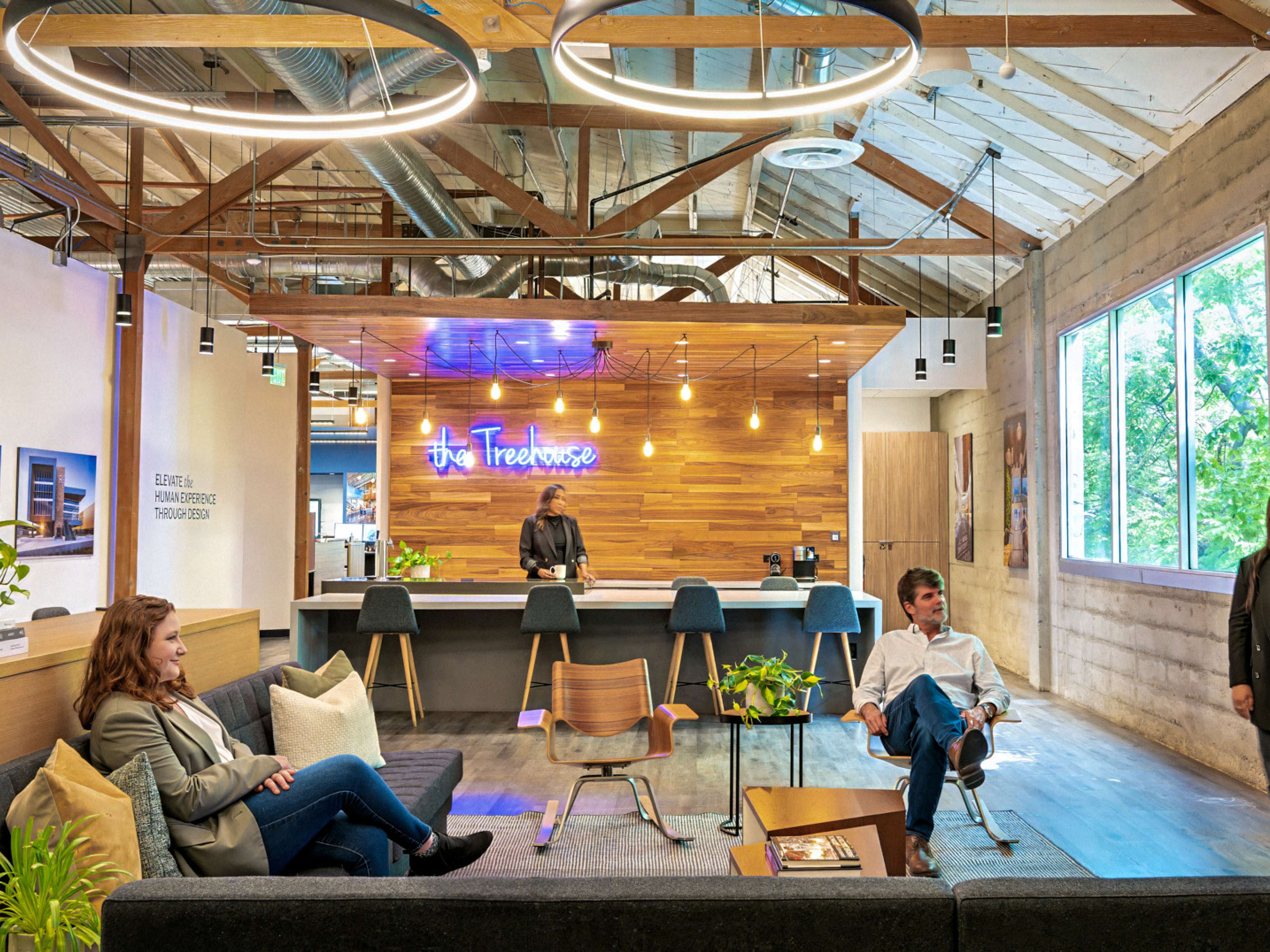 modern office collaboration zone with "the treehouse" coffee bar in the background; DLR Group Sacramento office