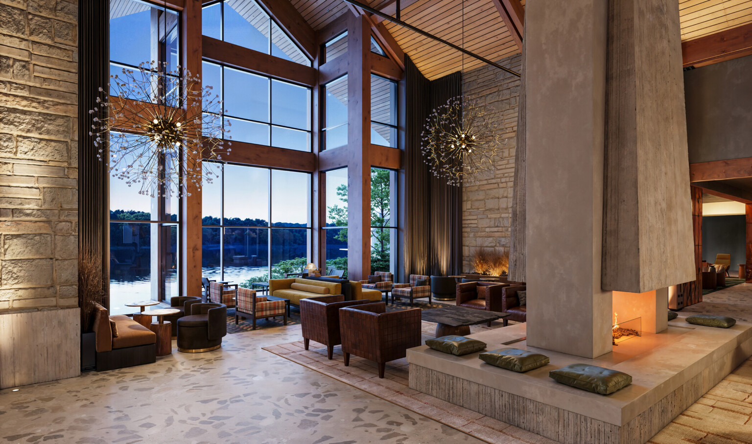 interior of a lodge-themed hotel lobby; rustic columns; stone walls; dark leather and wood interior tables and booths