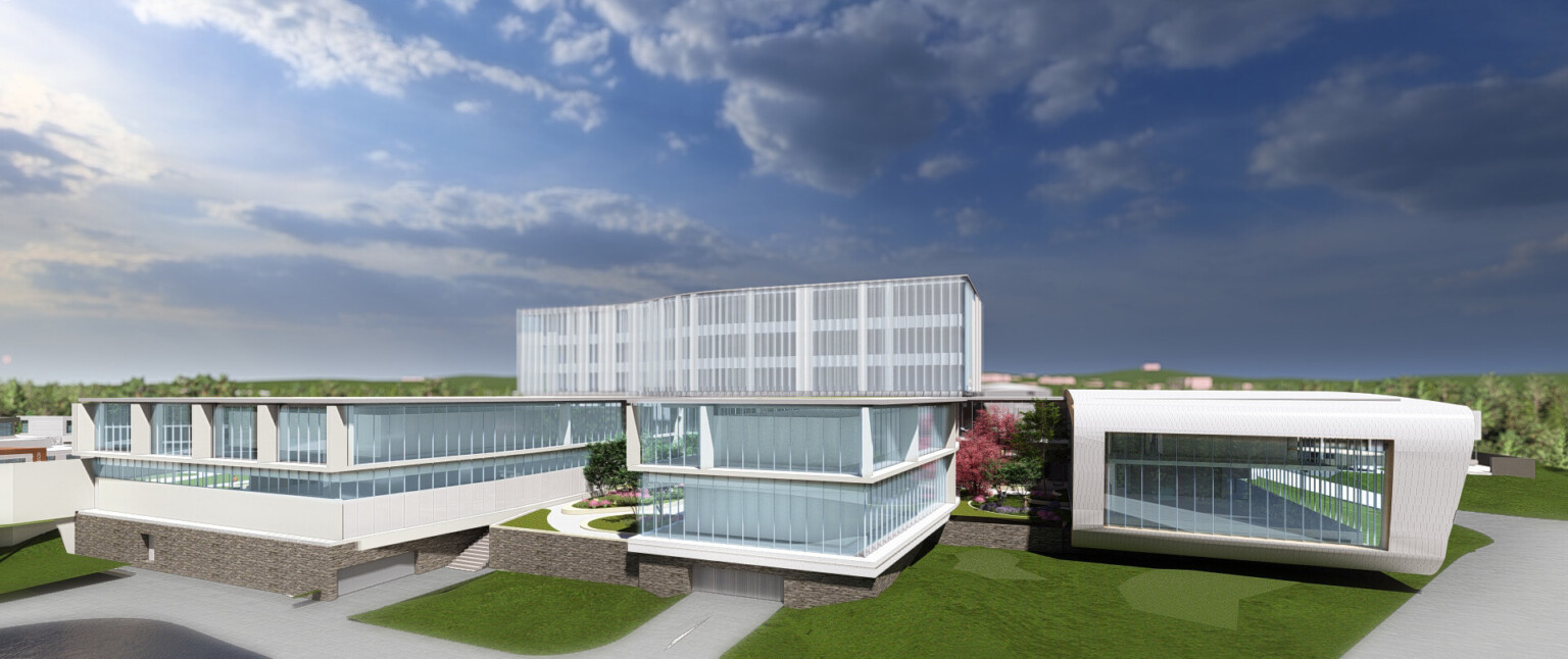 Long building on green lawn with large windows and white wrap facade