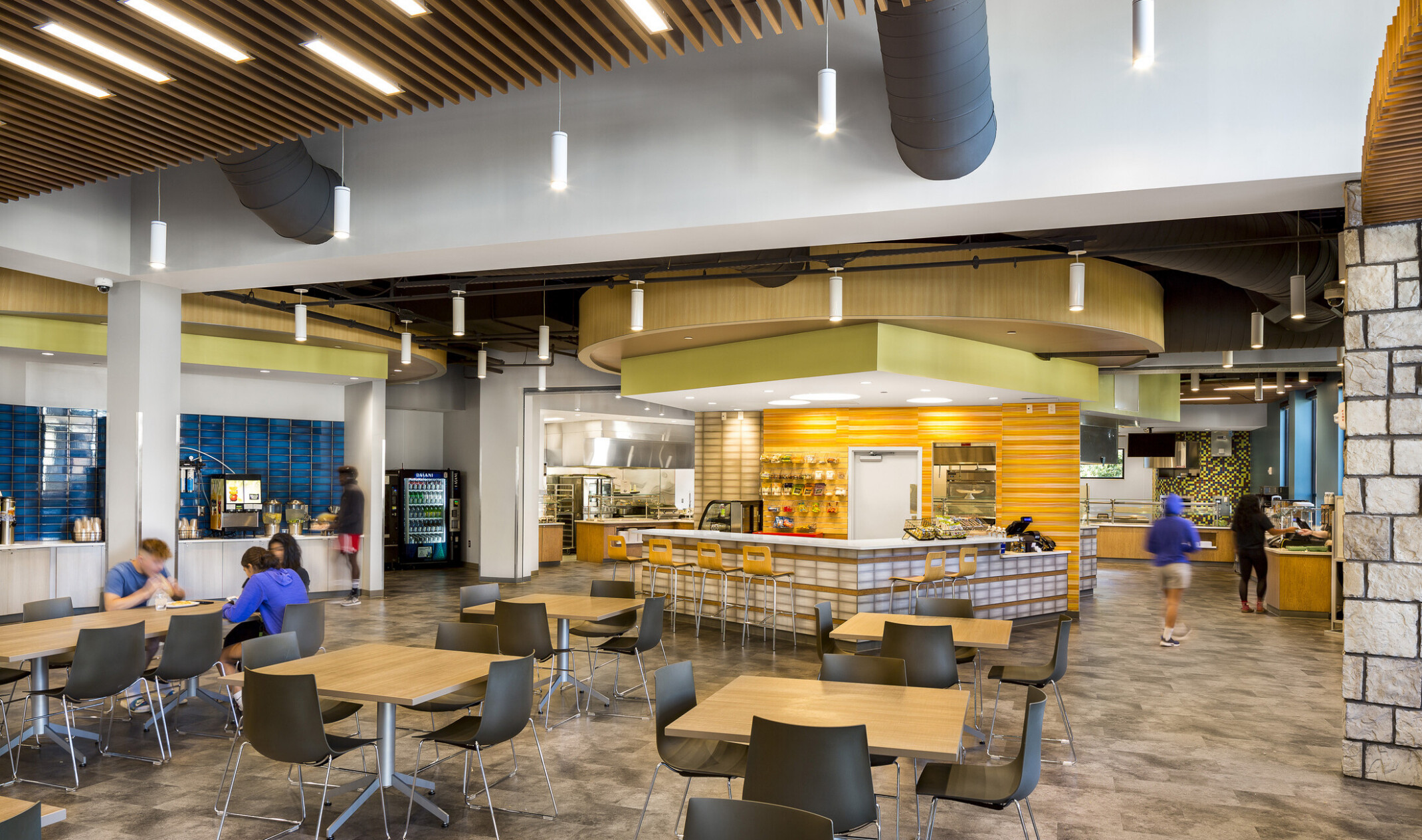 Life University Common space with modular tables, bar seating and food stations along the perimeter