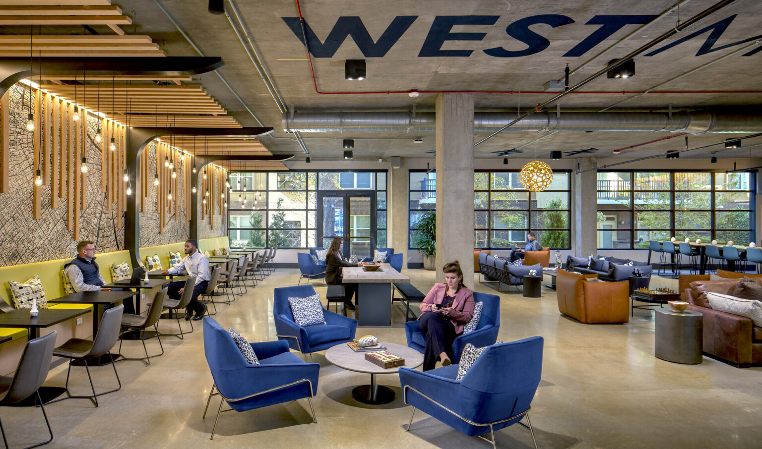 interior lounge area with blue chairs and low tables in gathering area of mass timber office, Hines T3 West Midtown interior lounge area with blue chairs and low tables in gathering area of mass timber office, Hines T3 West Midtown