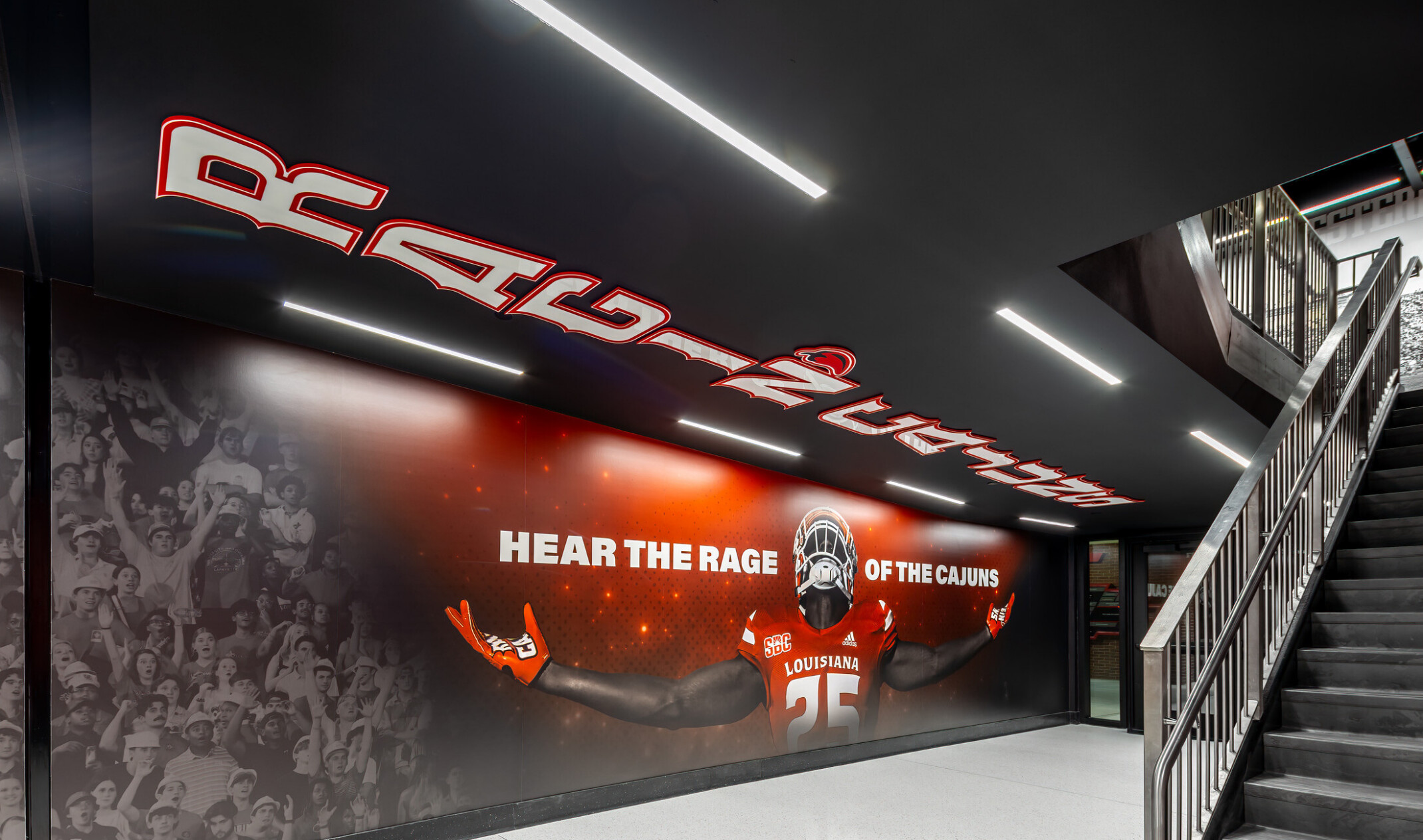 University of Louisiana Our Lady of Lourdes Stadium west bowl transformation; athletic walkway; red white and gray color palette with 