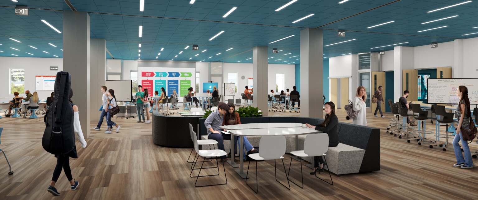 High school common area filled with students in multiple seating configurations interacting with technology and white boards