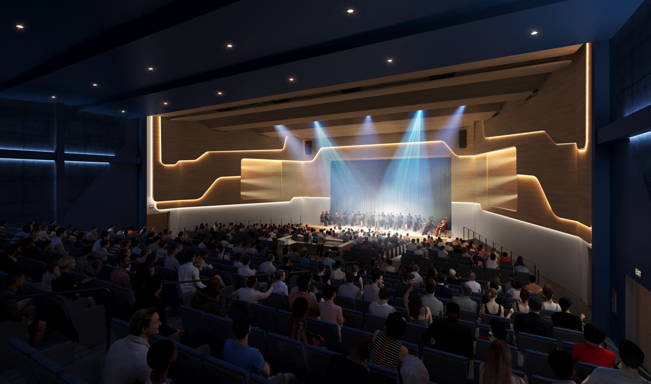Dark high school auditorium with a stage light by spotlights filled with students