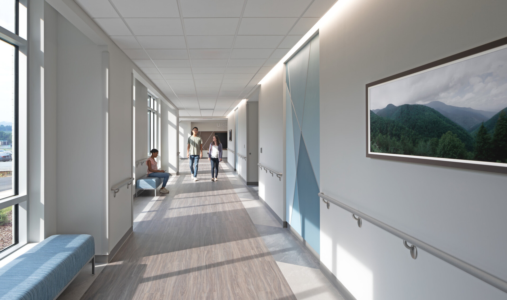 Calming blue and white hallway design with waiting room seats in the background