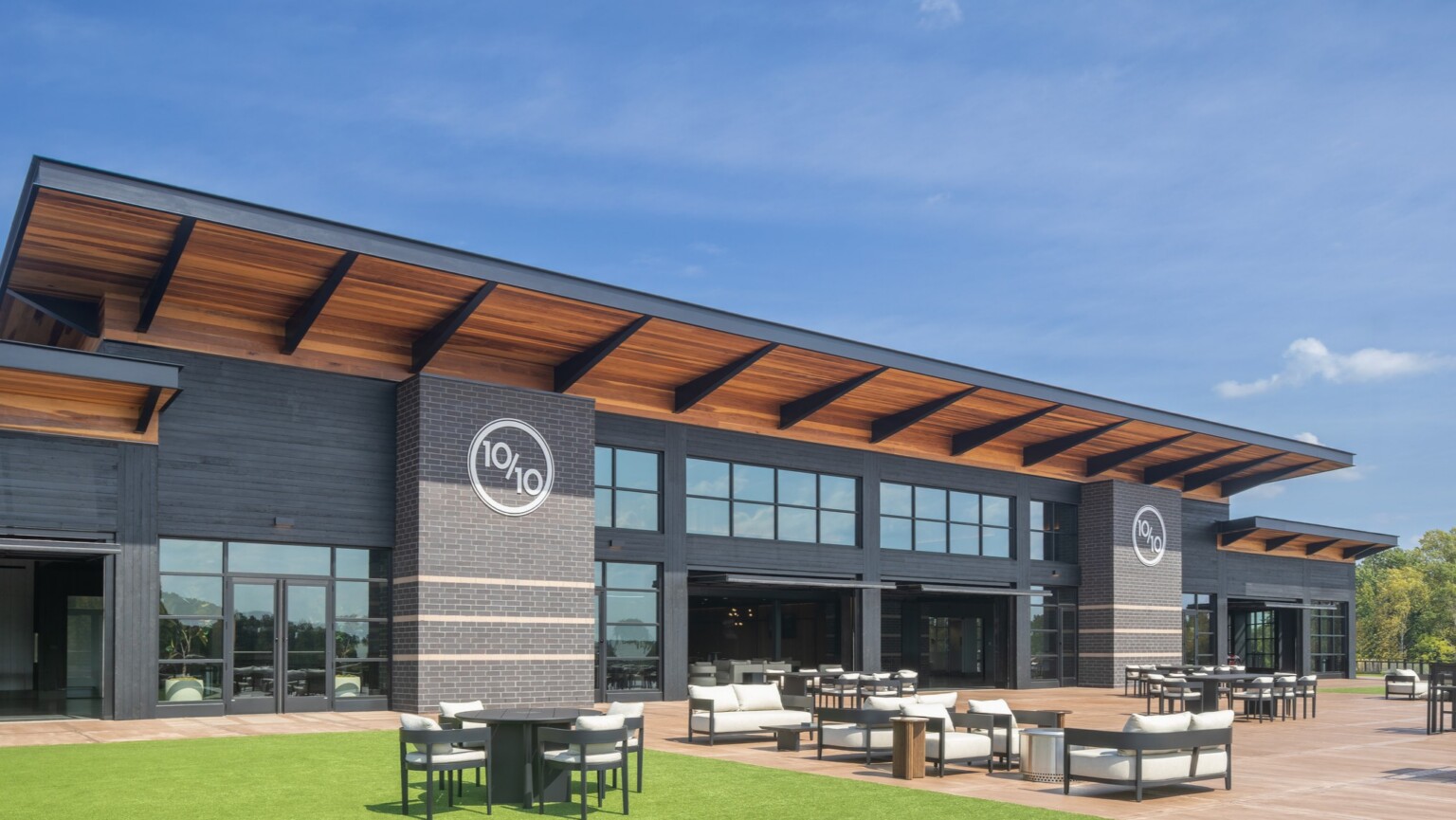 exterior of Ten Tenths Clubhouse; black exterior brick with a mass timber awning