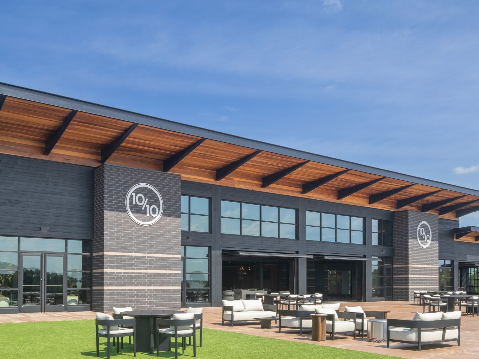 exterior of Ten Tenths Clubhouse; black exterior brick with a mass timber awning