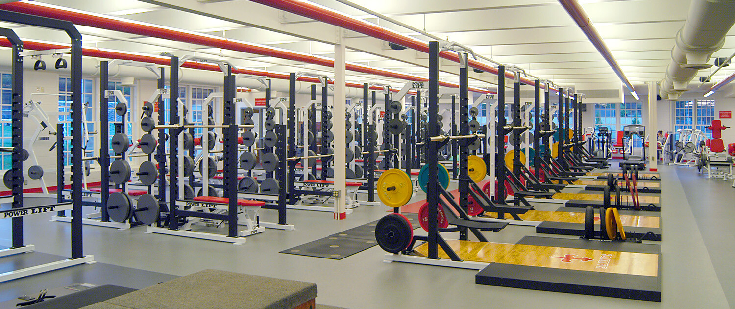 Indoor exercise gym filled with weight equipment with bright colored weights
