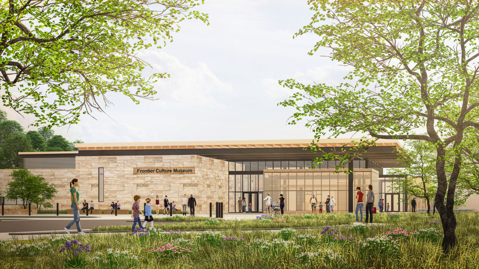 Modern museum building with stone walls and large glass windows stands in landscaped area with trees and flowers; Several people walking along a paved path in front of the building, which has a sign reading Frontier Culture Museum; bright and open, greenery framing the view