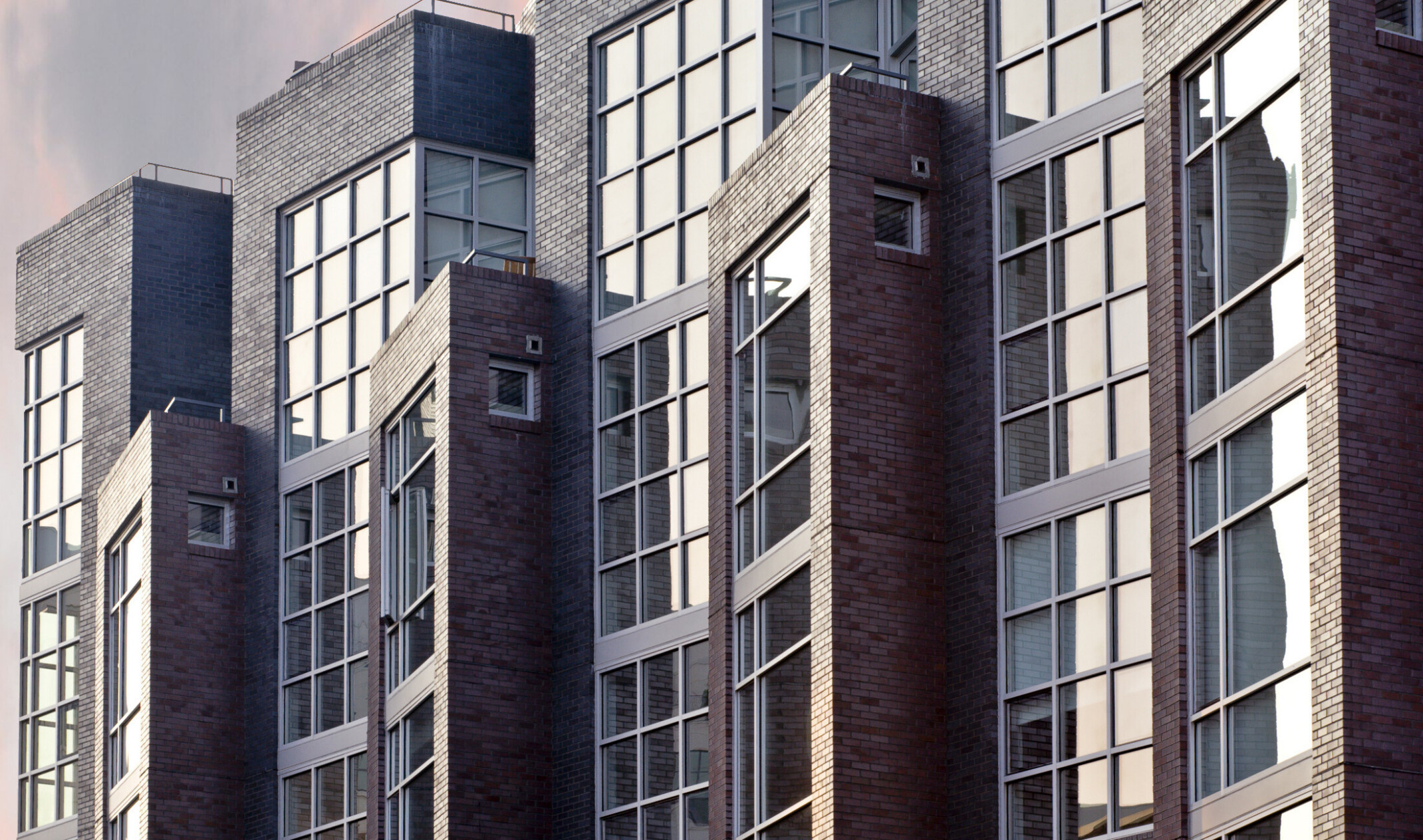 close up image of modern building facade with pop out architecture features and large windows
