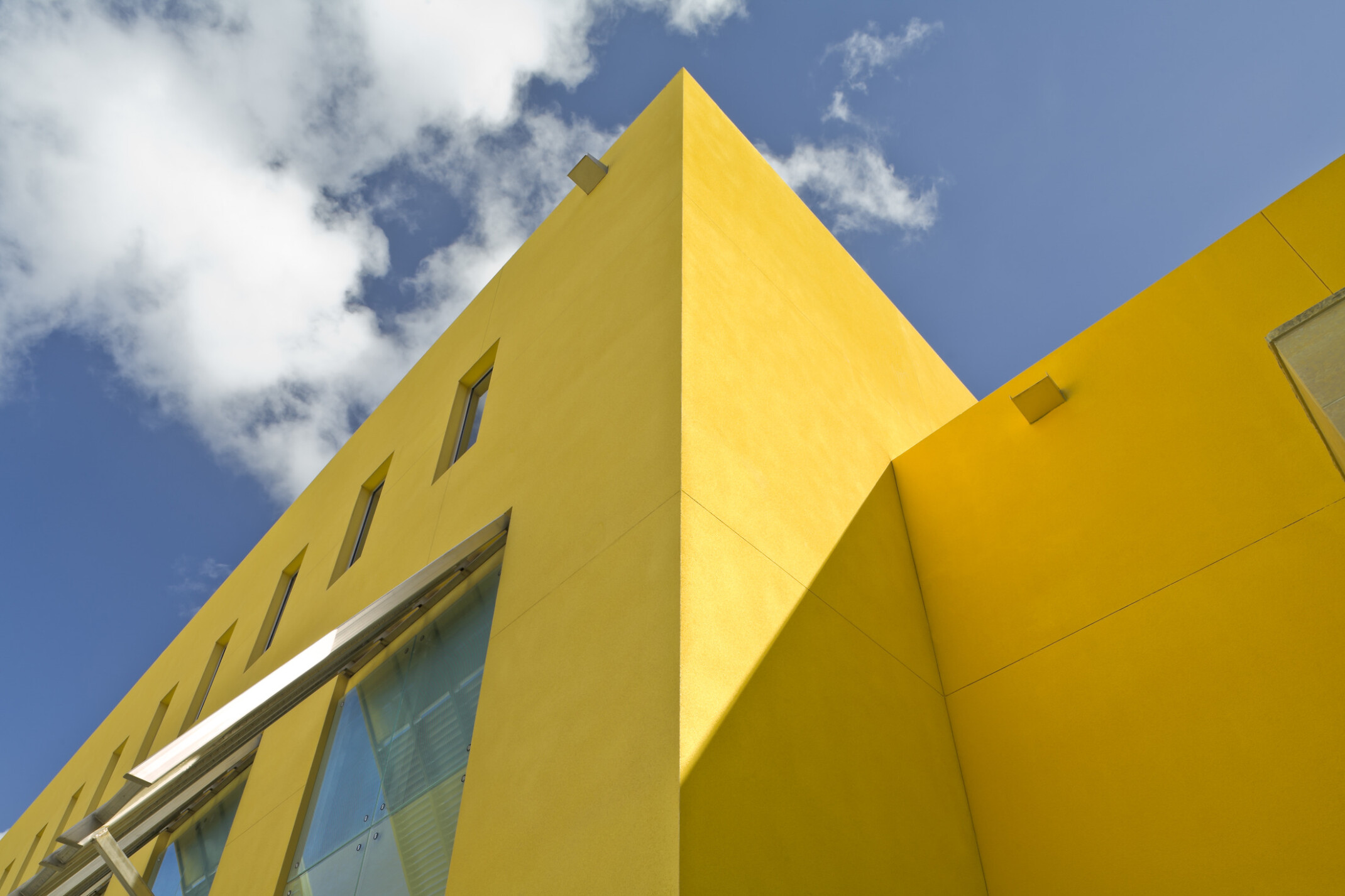 U.S. Embassy in Barbados a square yellow building with evenly repeating rectangular windows