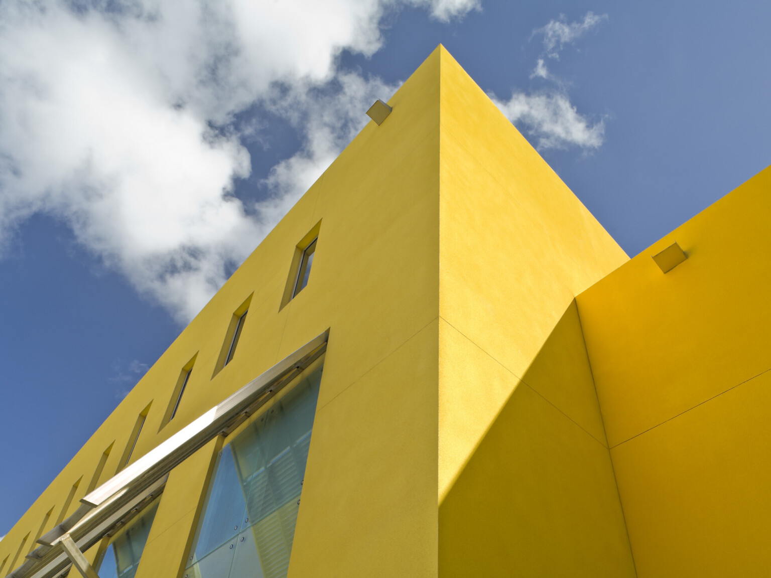 U.S. Embassy in Barbados a square yellow building with evenly repeating rectangular windows