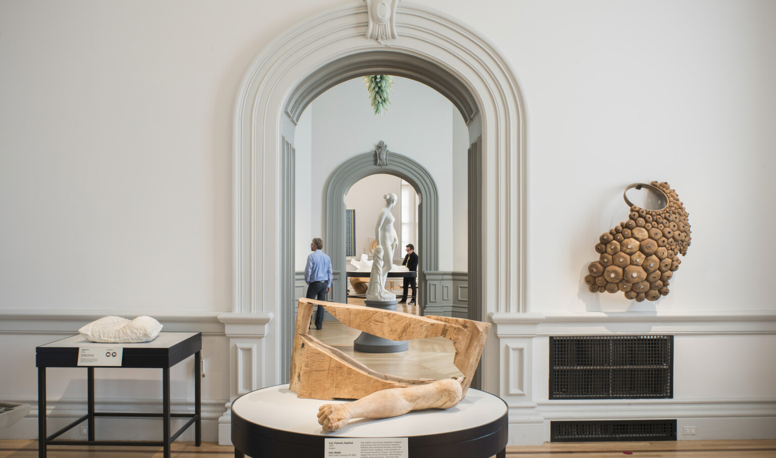 Abstract art object table display framed at back by arched door with crown molding at the renwick gallery