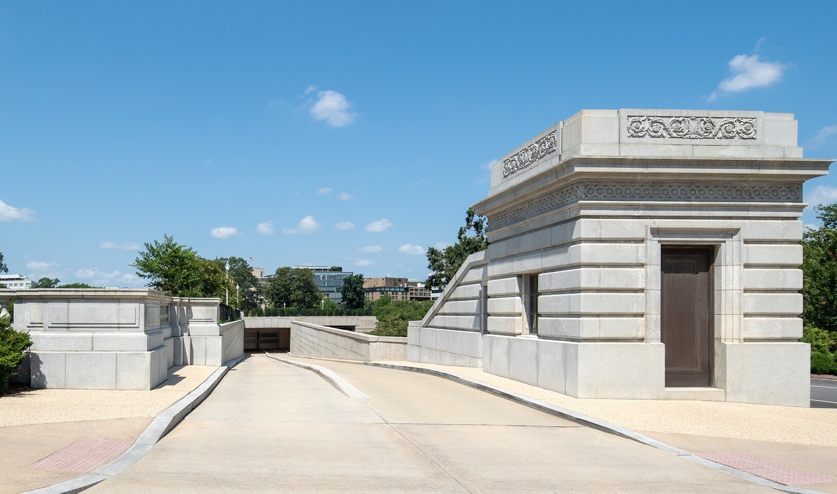 The entrance to the underground garage features a cement facility’s entrance to the right.