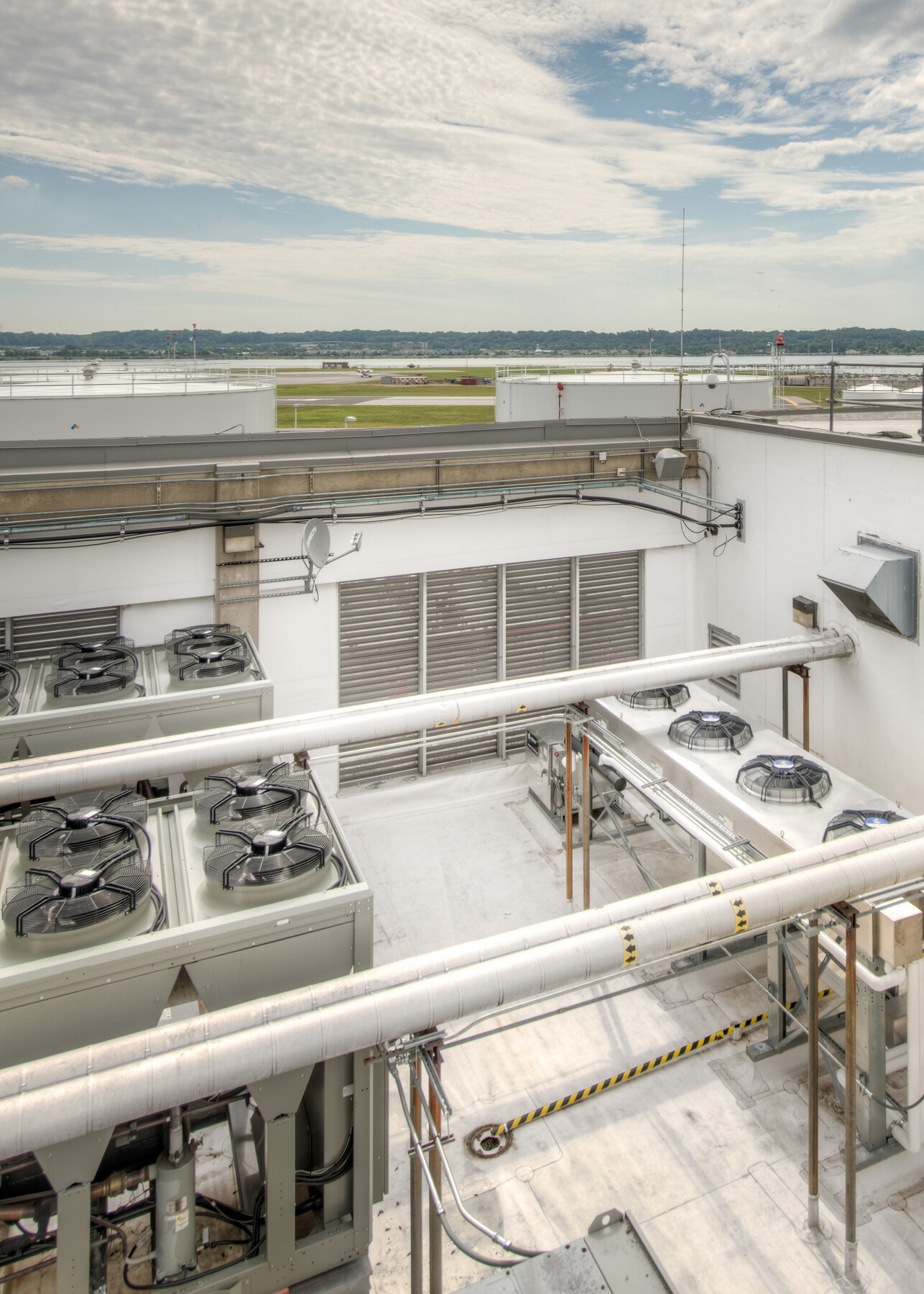 Rooftop view of upgraded HVAC system with visible units against the horizon. Caption: Upgraded rooftop HVAC system enhances temperature control for the testing facility.