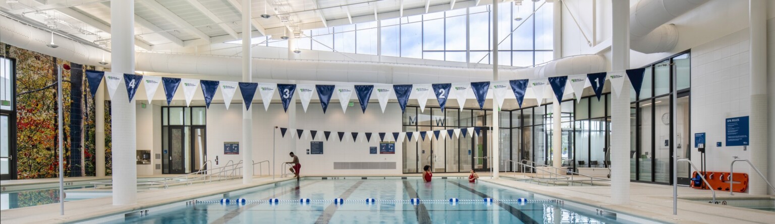 community pool at Southern Regional Technology & Rec Complex Aquatic Facility; geometric ceiling cutouts bring in natural light; light and airy space