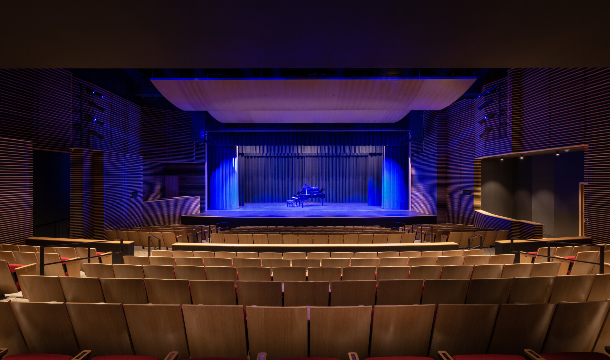 back of house view of a stage lit with blue lights