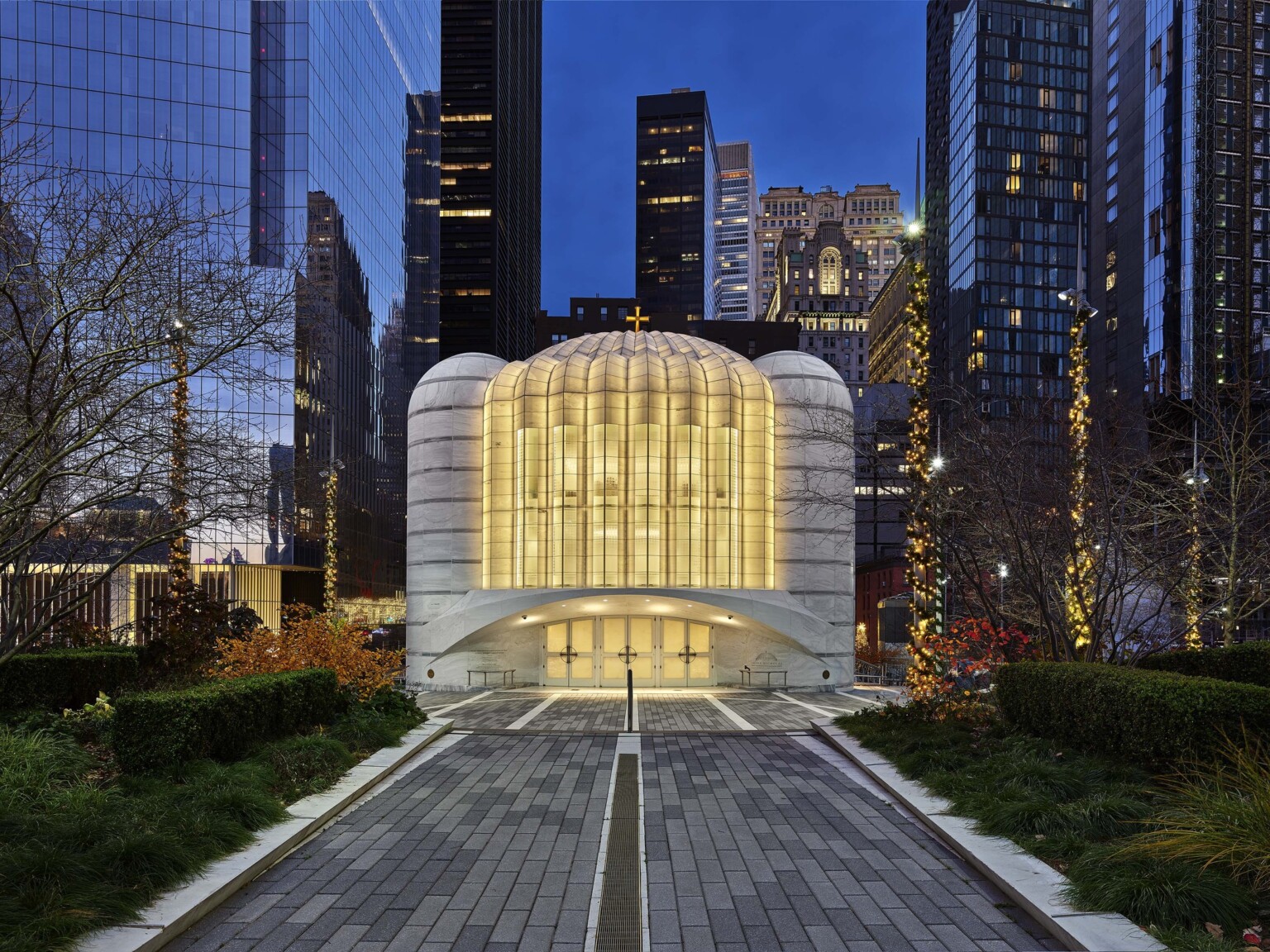 Saint Nicholas Greek Orthodox Church illuminated in the evening, a white and rounded building at the new World Trade Center in New York City