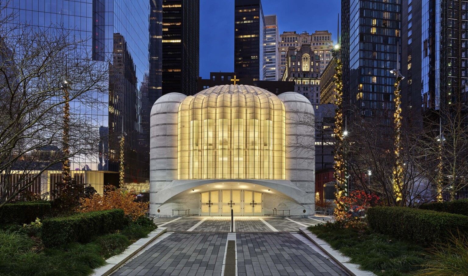 Saint Nicholas Greek Orthodox Church illuminated in the evening, a white and rounded building at the new World Trade Center in New York City