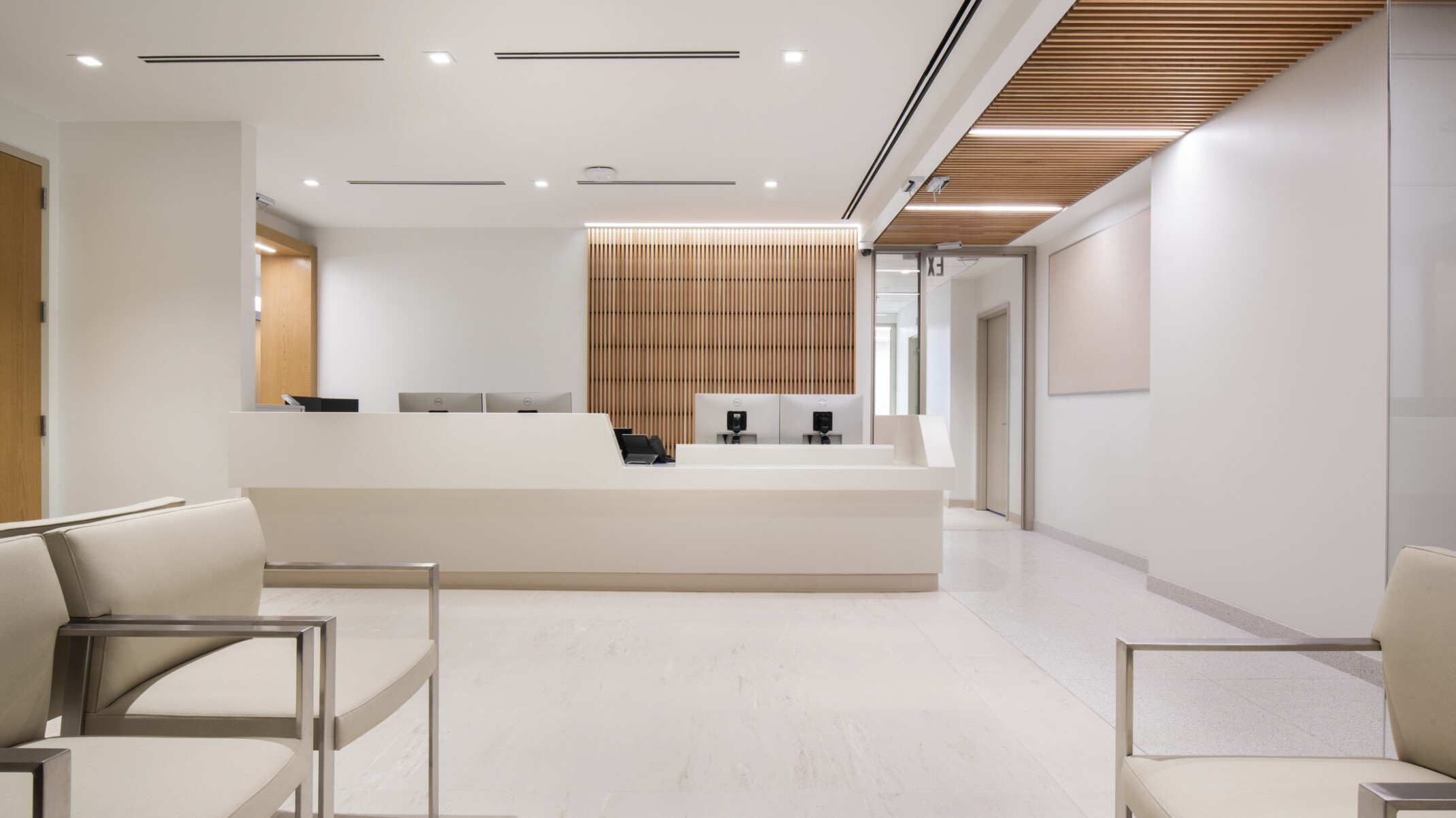 reception area for Mt. Sinai cardiology, soothing cream colors for walls, flooring and ceiling, skylights provide a serene connection to nature, two primary wayfinding devices – exterior windows along the corridor and natural wood - help patients understand their current location and how to navigate to their destination