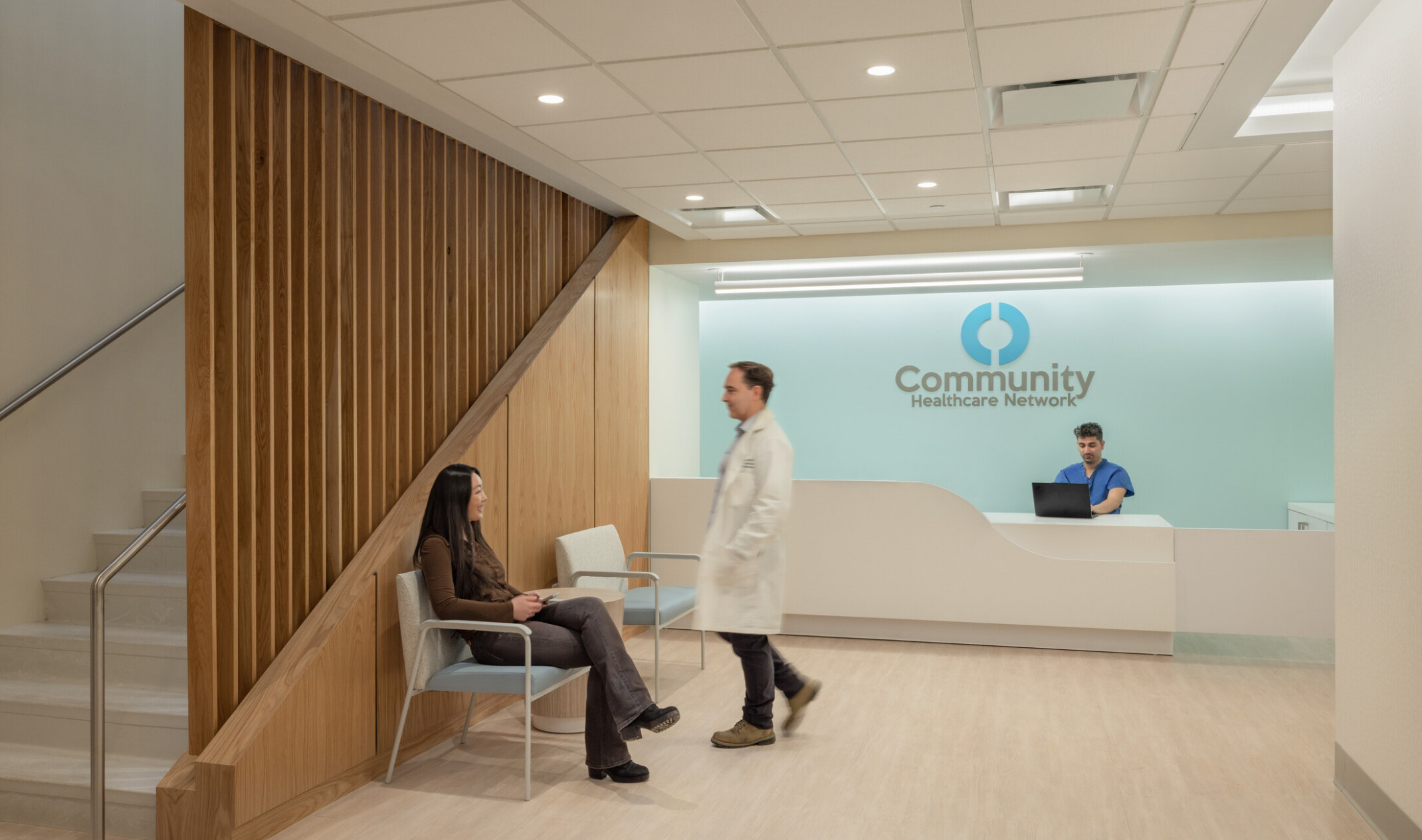 patient waiting area with background front desk; blue lighting wall