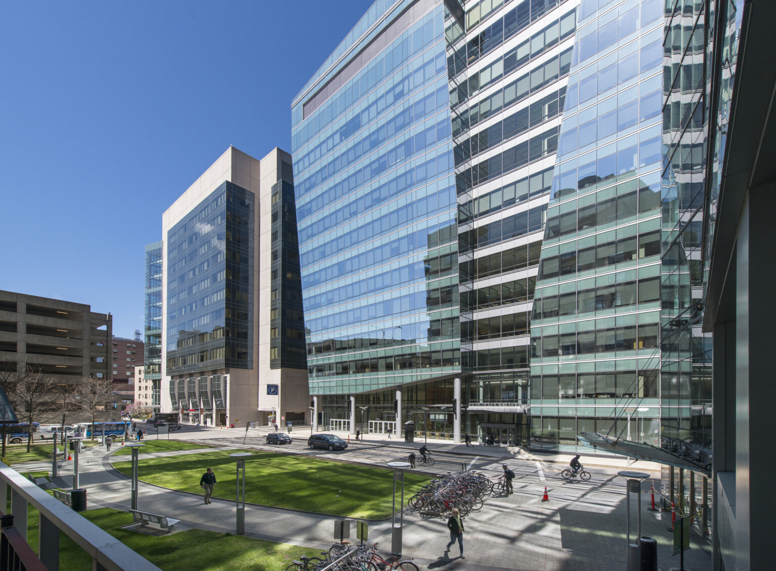 Tall glass medical office buildings with multiple floors and large windows, arranged in a modern urban business district setting.