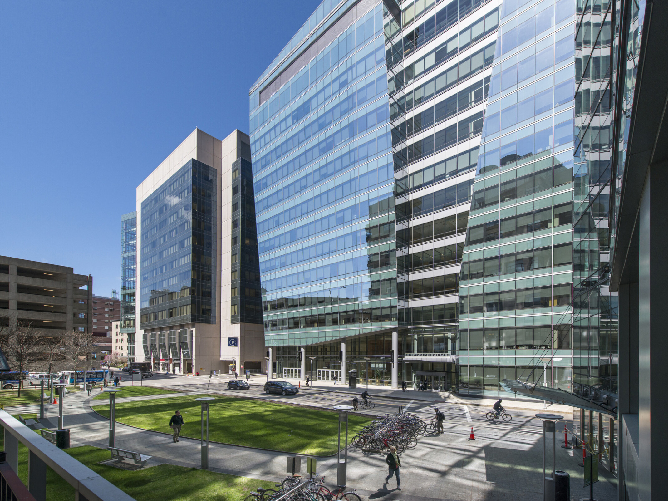 Tall glass medical office buildings with multiple floors and large windows, arranged in a modern urban business district setting.