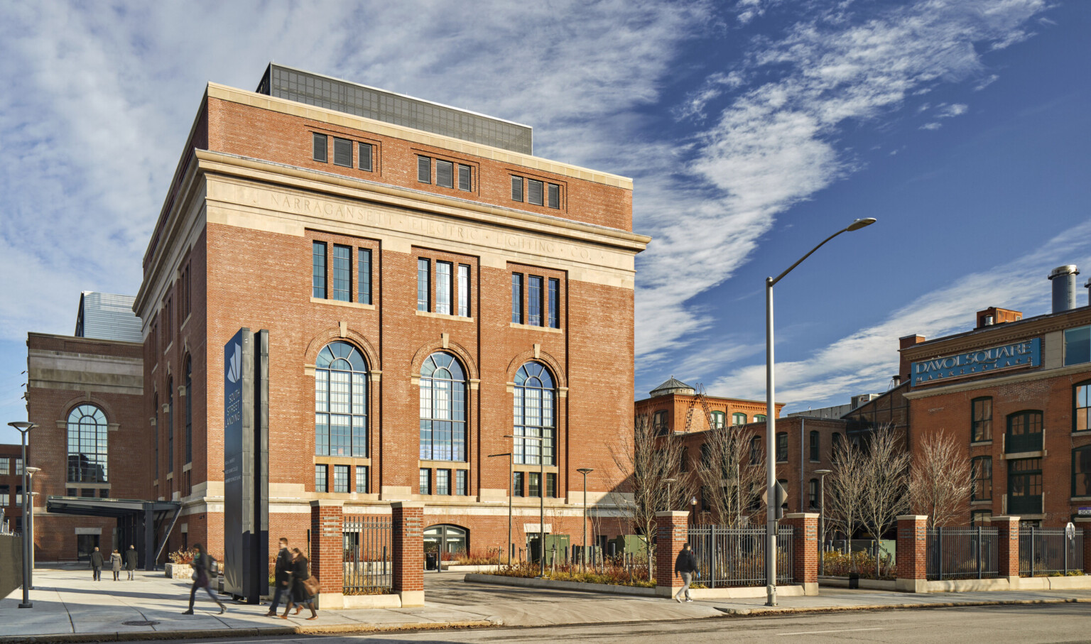 outside view of the south street landing; Older style building with original "Narragansett electric lighting co." stone engraving; now a healthcare education facility