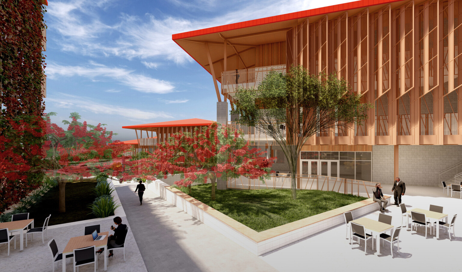 Courtyard with seating along stone pathway, trees and green space. Back, stone building with red canopy roof and wood accents