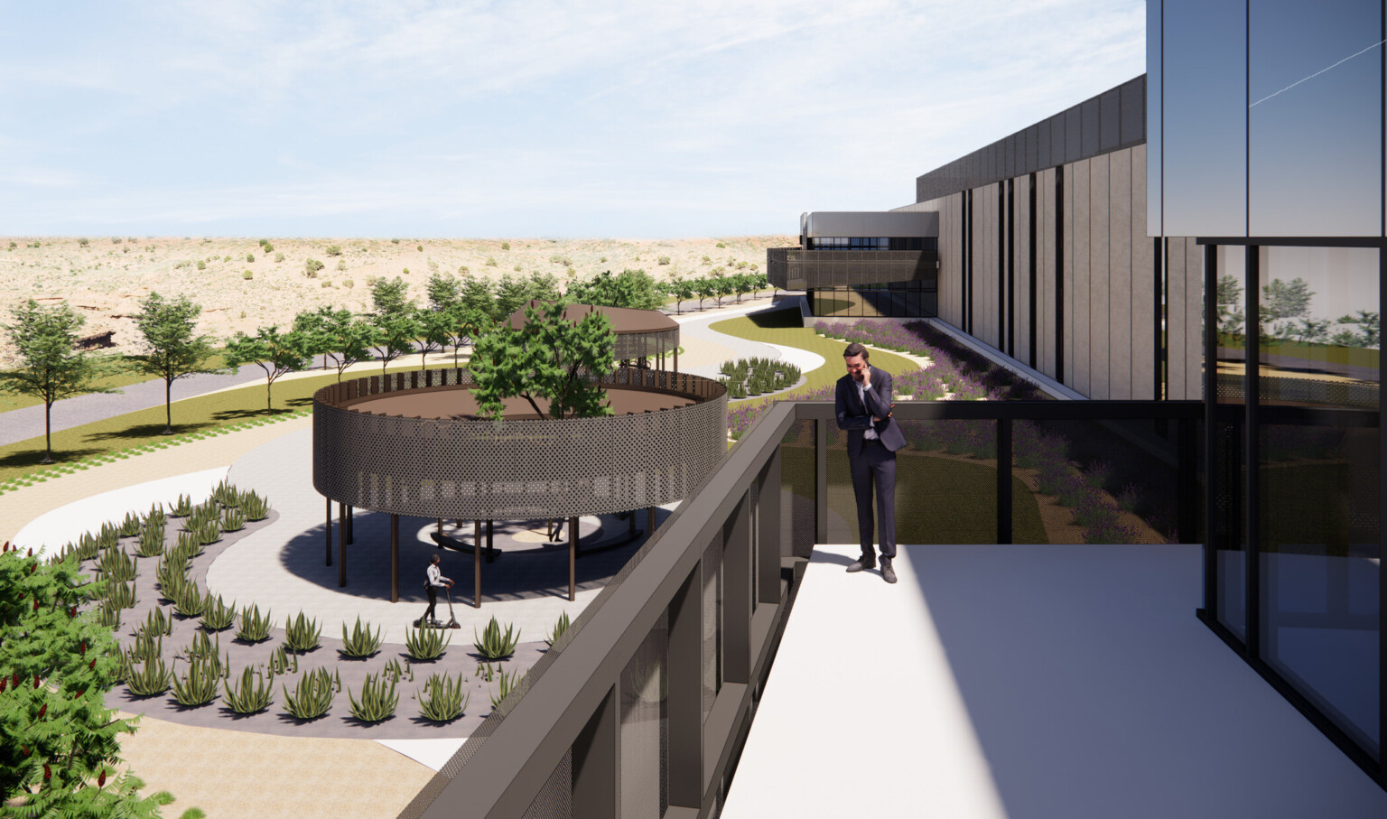 design rendering of man talking on mobile phone on second-floor terrace, tree-lined commons and pathway to entrance, succulents, grass, man on scooter below, surrounding hills, and blue sky