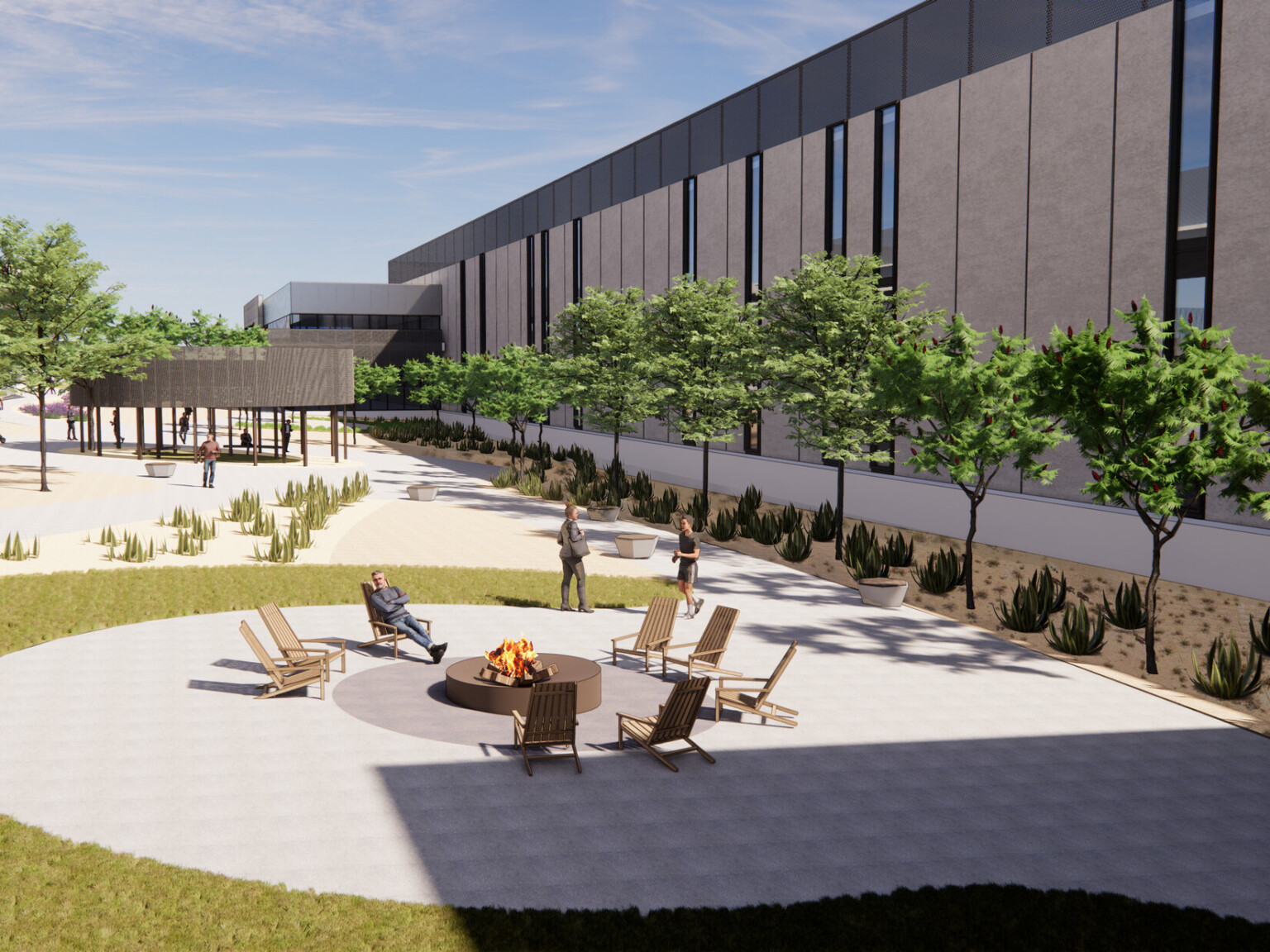 Outdoor amenities such as a fire pit with seating and walking trail around the exterior of data center building clad in prefabricated, concrete palette with linear window cutouts