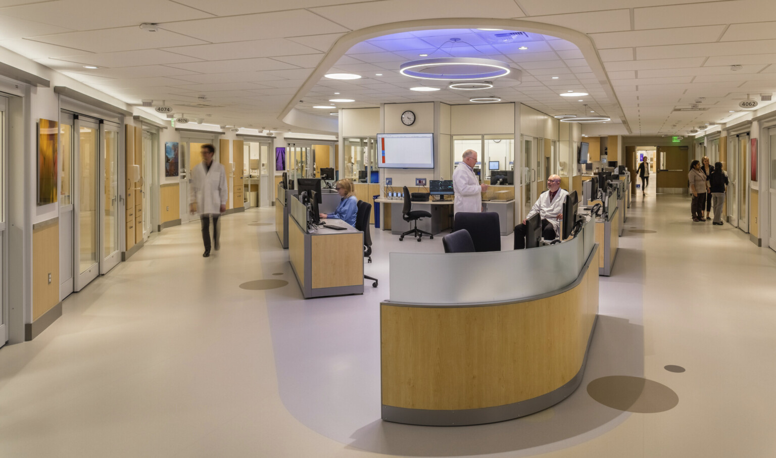 Modernized hospital nurses station, reception area, light birch wood furniture modules, muted wall and flooring palette, well-lit Modernized hospital nurses station, reception area, light birch wood furniture modules, muted wall and flooring palette, well-lit