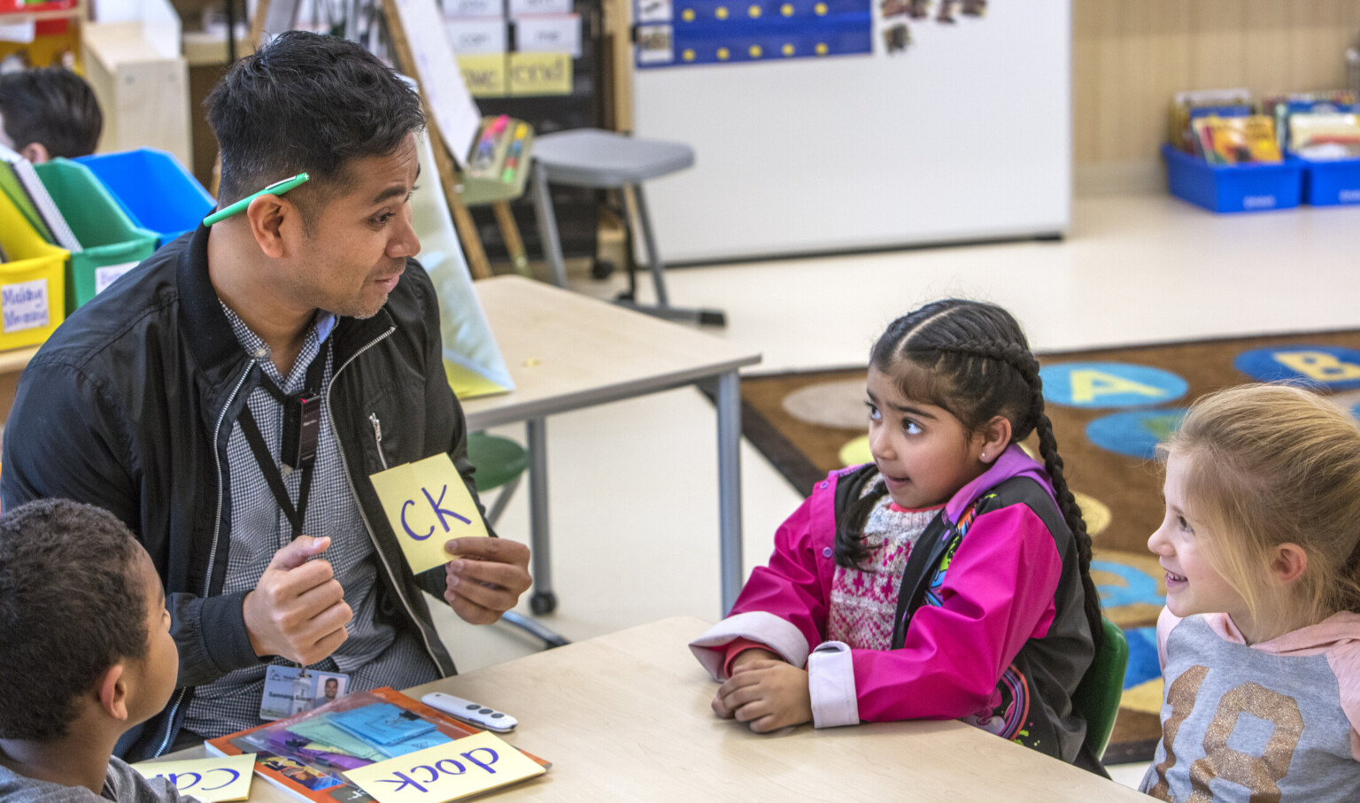 Educator working with students on phonics at Pathfinder Kindergarten Center. Mixed flexible learning spaces Educator working with students on phonics at Pathfinder Kindergarten Center. Mixed flexible learning spaces