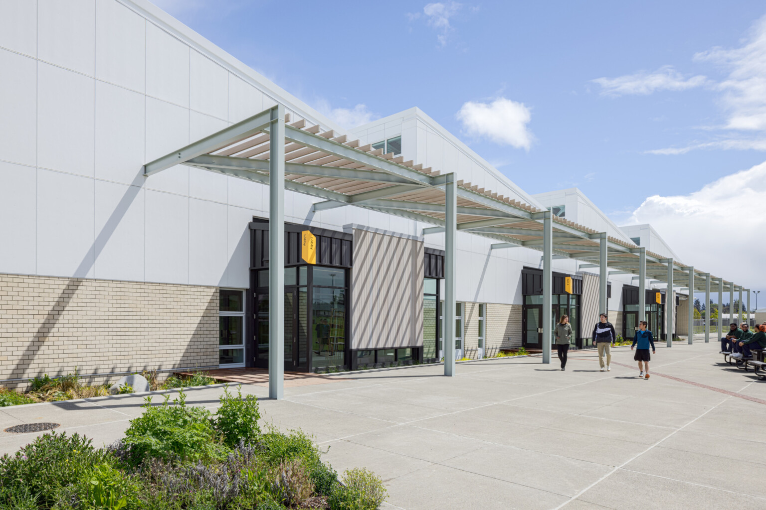 front entrance to a activities and wellness center; featured steel frame with doors beneath