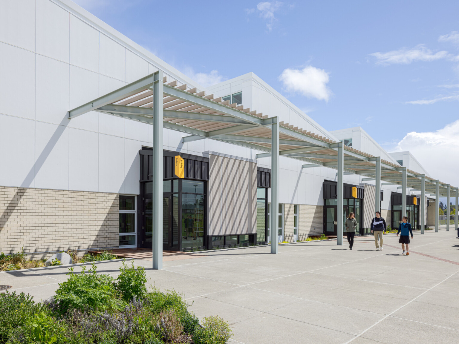 front entrance to a activities and wellness center; featured steel frame with doors beneath