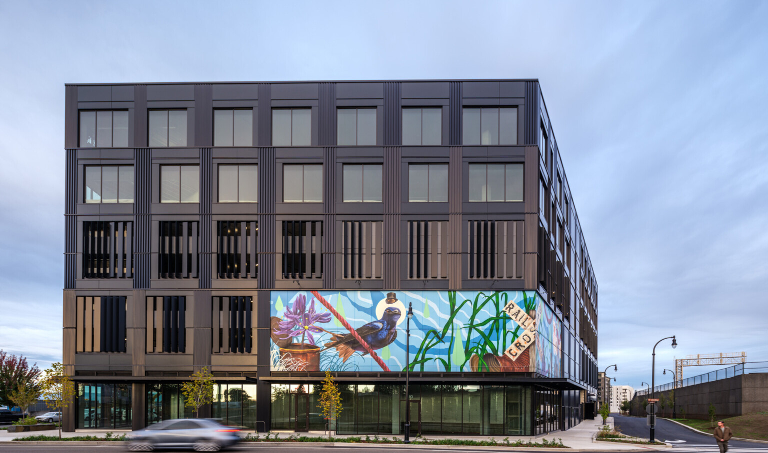 large exterior mural on a building facade; colorful mural depicts nature; mixeduse development in vancouver, wa